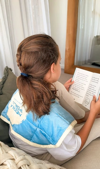 Child using a MEEKA Weighted Shoulder Wrap in a quiet space